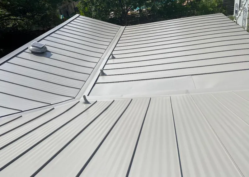 Solar attic fan installed on a metal roof for Roof Ventilation in Long View